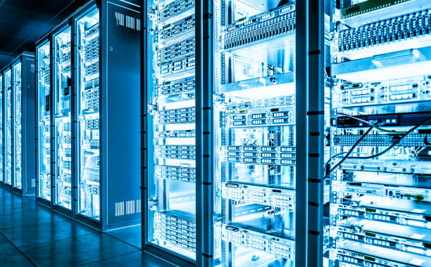 Servers in rows on metal shelves in dark cooling room